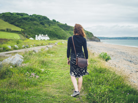 Young woman walking near the coast