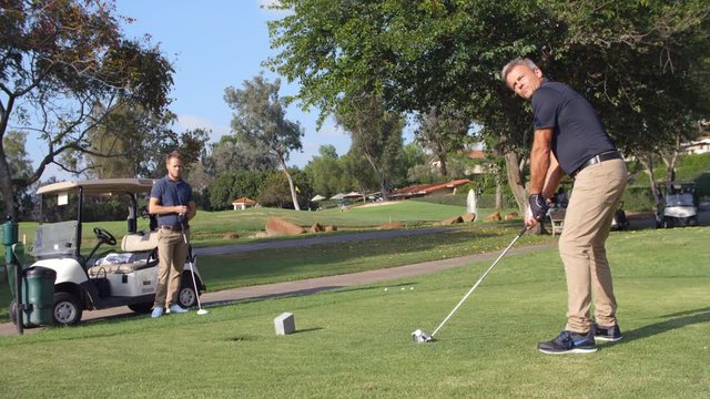 Slow Motion Shot Of Male Golfer Playing Tee Shot 