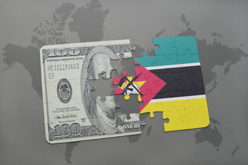 puzzle with the national flag of mozambique and dollar banknote on a world map background.