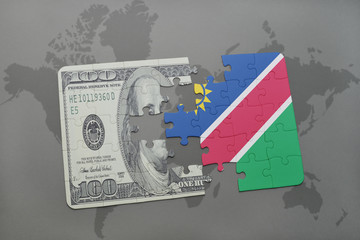puzzle with the national flag of namibia and dollar banknote on a world map background.