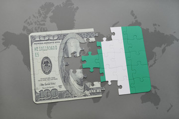 puzzle with the national flag of nigeria and dollar banknote on a world map background.