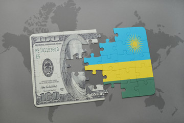 puzzle with the national flag of rwanda and dollar banknote on a world map background.