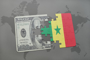 puzzle with the national flag of senegal and dollar banknote on a world map background.