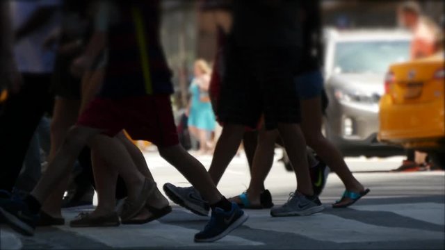 crowd of people crossing street in new york city. workers commuting background