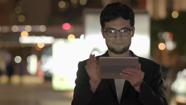 modern mobil device technology background. asian man surfing the web on  tablet