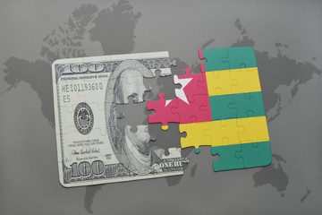 puzzle with the national flag of togo and dollar banknote on a world map background.