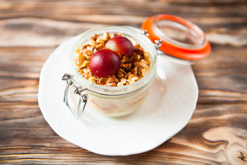 Sweet dessert - chocolate and vanilla pudding with grapes and nu