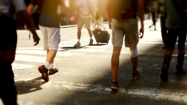 people walking on crowded street in the city. pedestrians commuters background