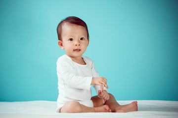 Baby happy on the blue background, new family and love concept (