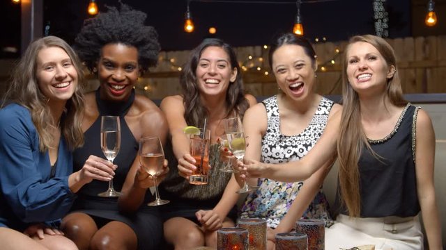 Female Friends Enjoying Night Out At Rooftop Bar, Slow Motion