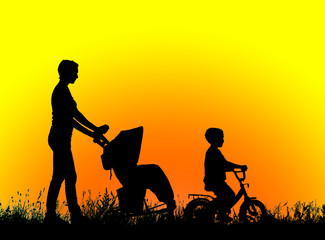 Fototapeta na wymiar silhouette mother with children walking at sunset