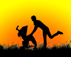 Obraz premium silhouette of a woman walking with a baby stroller at sunset