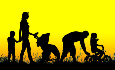 silhouette of a large family that walks at sunset