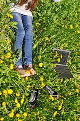 legs and notebook with yellow dandelion