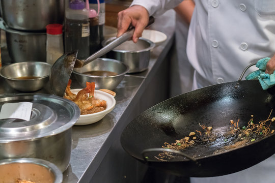 Detail of a line chef preparing Chinese food
