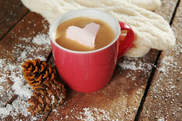 Cup of coffee with marshmallow on wooden table