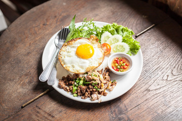 Fried egg with rice  on wooden table