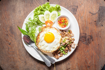 Fried egg with rice  on wooden table
