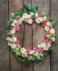 Assorted roses heads on wooden background