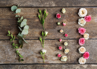 Assorted roses heads on wooden background
