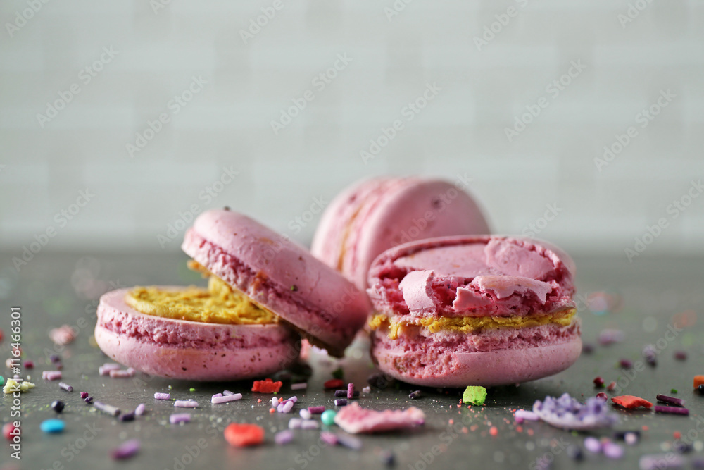 Wall mural pink broken tasty macaroons on gray table