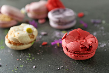 Red broken tasty macaroon on gray background