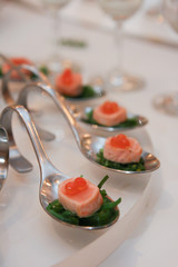 salmon on elegant silver spoons.