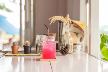 Raspberry lemonade with ice in mason jar