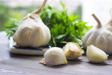 Garlic and parsley on wooden table