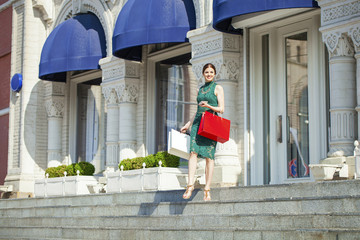 Young brunette woman with some shopping bags