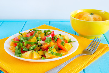 Fresh salad with spinach, bell pepper and yellow tomatoes in whi