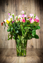 Mixed beautiful flowers on wooden background