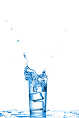 Glass of water with ice cubes on white background