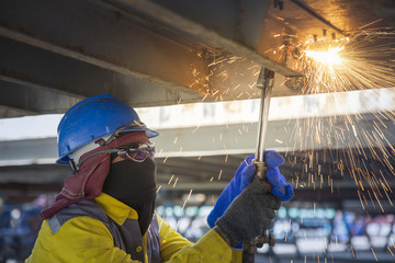 Worker cut the steel base for repair container