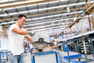 Asian worker in production plant on the factory floor