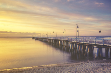Naklejka premium wooden pier on the Baltic Sea, Gdynia Orłowo, Poland.Seascape,sunset, retro effect