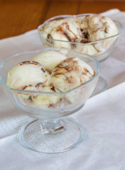 Vanilla sundae ice cream with sauce in cup. Selective focus