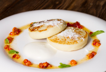 Cheesecakes with sour cream and jam of sea-buckthorn