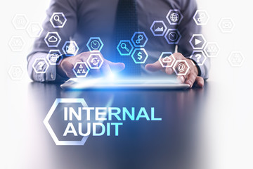 Businessman is using tablet pc and selecting Internal audit icon.