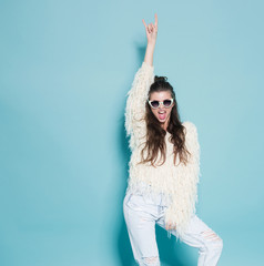 portrait of cheerful fashion hipster girl going crazy making funny face and dancing. Blue color background. - 116482963