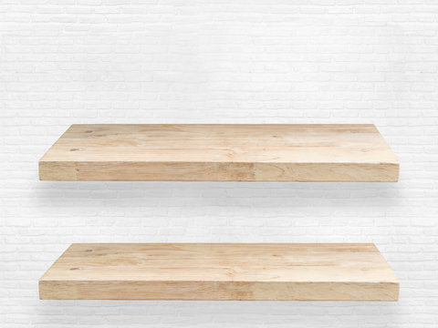 two wooden shelve on brick wall