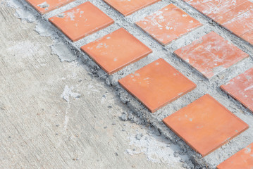 Worker making sidewalk pavement with stone blocks