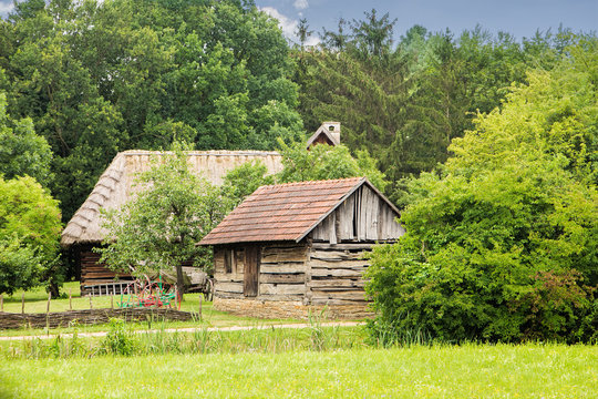 Rustic vintage peaceful country scene, old wooden houses with hi