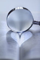 Heart shaped light through a magnifying glass
