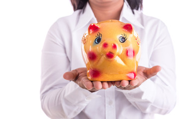 Woman holding yellow piggy bank isolated on white