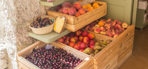 fresh pears and apricots in wooden crates