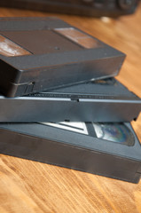 VHS cassettes on a wooden table