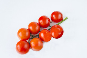 Eight red tomatoes on a white background