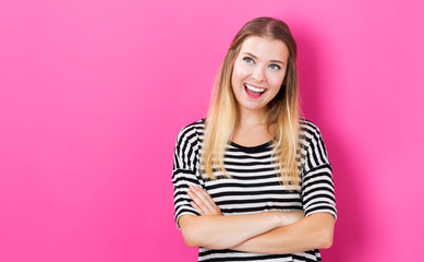 Happy young woman with pink background