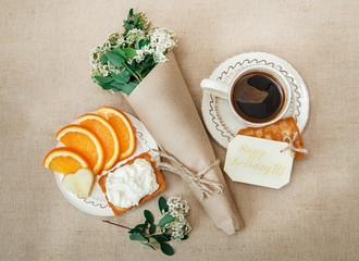 Romantic Birthday Healthy Breakfast.Cup of Coffee,Cut Orange,Biscuit with Cottage Cheese.Wish Card with Flowers